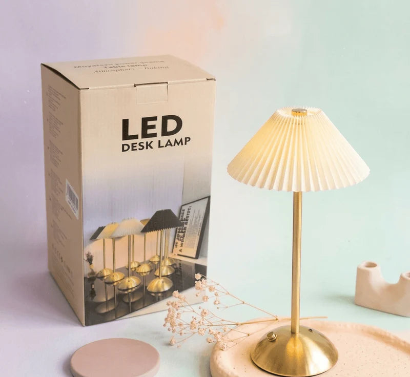 Zyvoura Elegant Pleated LED Desk Lamp with a sleek design and adjustable arm for focused lighting on a desk.