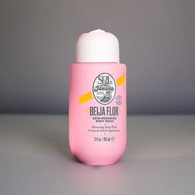 Zyvoura Sol de Janeiro Beija Body Wash and Gel in a clear bottle with a yellow and pink label, showing the product's vibrant packaging.